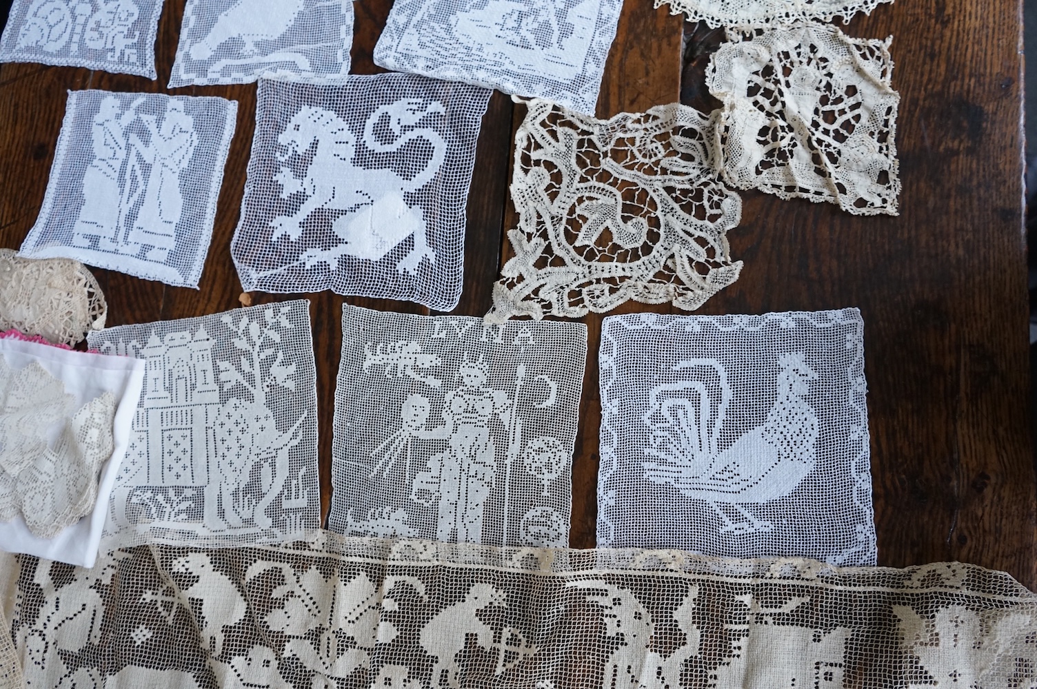 A good collection filet lace including a wide figurative elephant panel, square inserts, mats, trimming etc, with two Normandy lace mats, a cutwork mat and bobbin lace inserts.(40). Fillet panel 112cm long x 27cm wide. C